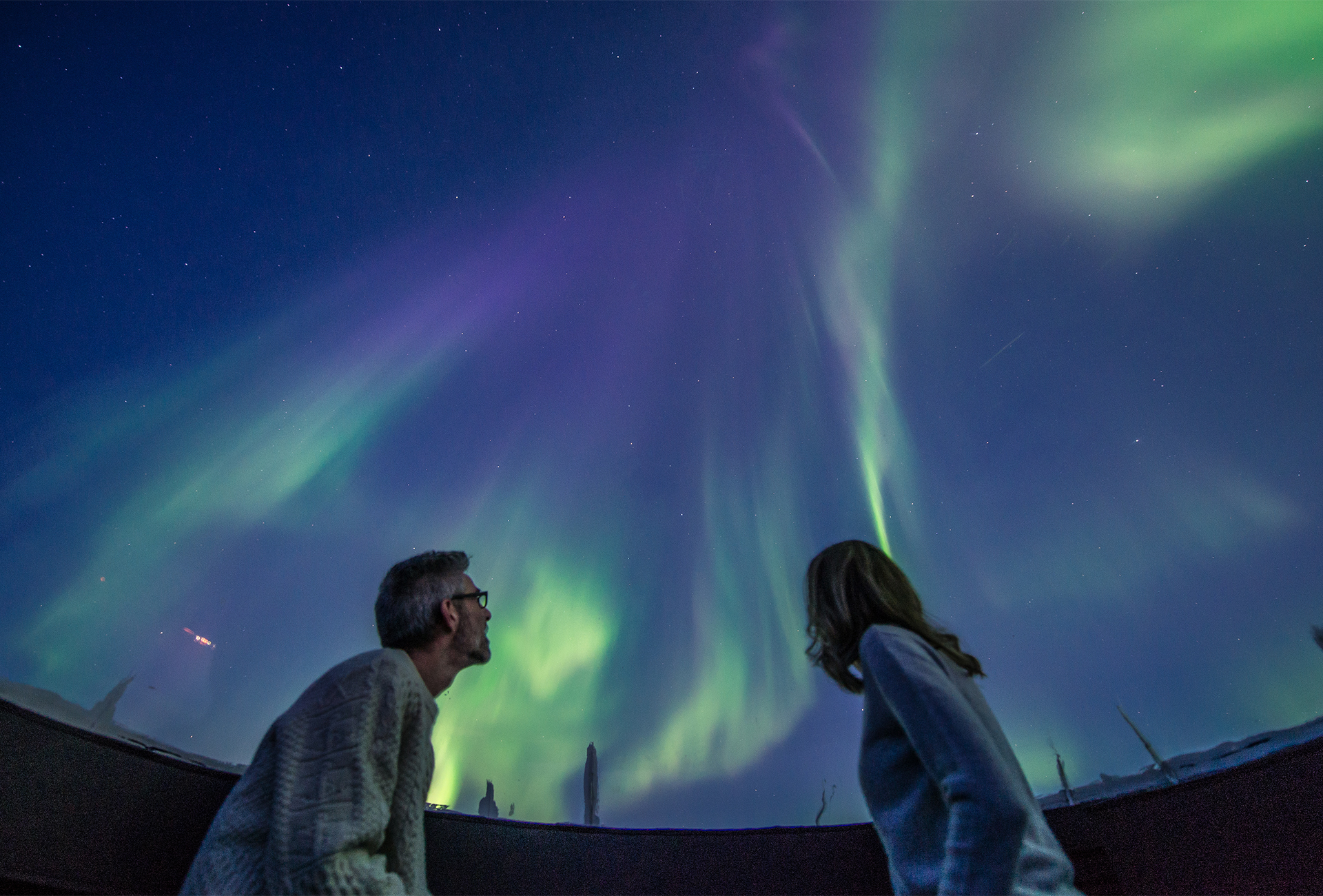 Guests look up at northern lights from Aurora dome churchill canada